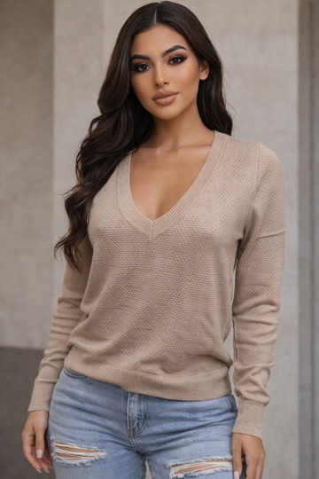 Unleash your edge with this long-sleeve V-neck top that commands attention. The structured  